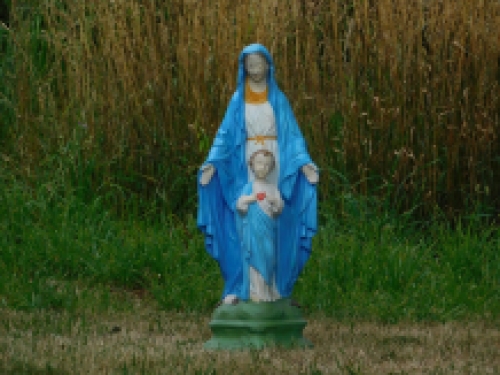 Mary with Jesus' sacred heart, full of stone church statue.