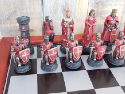 A chess game with the theme: ''MEDIEVAL KNIGHTS'', beautiful chess pieces like medieval knights on a wooden chessboard.