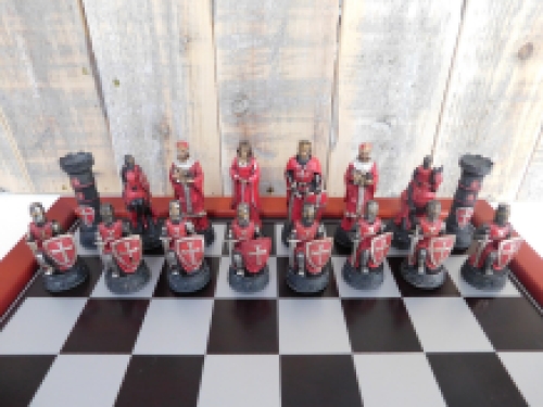 A chess game with the theme: ''MEDIEVAL KNIGHTS'', beautiful chess pieces like medieval knights on a wooden chessboard.