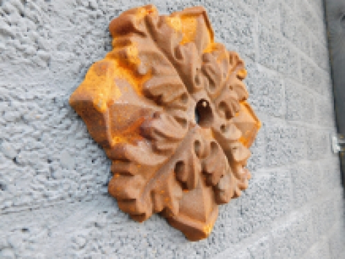 Wall anchor, cast iron, rust brown, leaf shape.