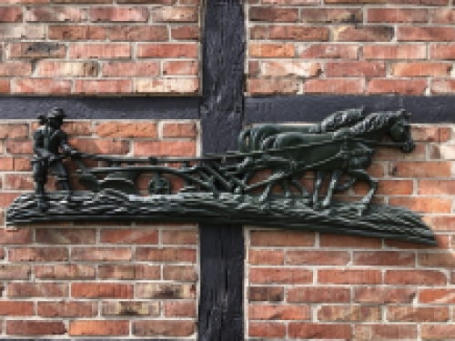 Wall decoration XXL , aluminium green fireplace plate farmer with horse and plough.