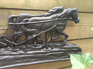 Wall decoration , cast iron black fireplace plate farmer with horse and plow.