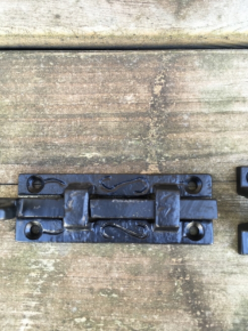 A beautiful door latch / slide lock, matte black, made of wrought iron