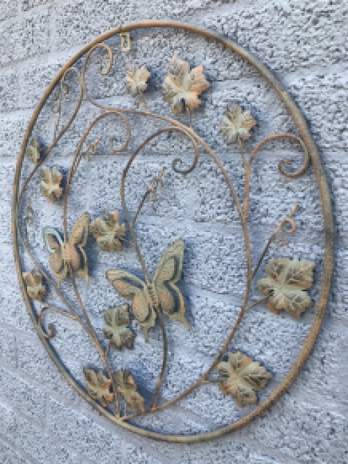 A metal wall ornament with leaves and butterflies, very decorative!