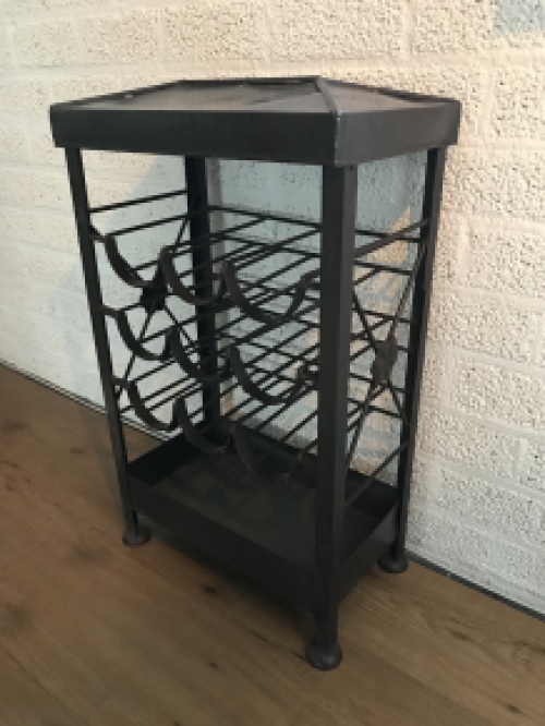 An antique wine rack, metal wine holder for 9 bottles of wine