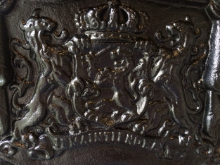 Zwaart gietijzeren wandornament, zwaar uitgevoerd met de spreuk: Je maintiendrai (ik zal handhaven), hofleverancier