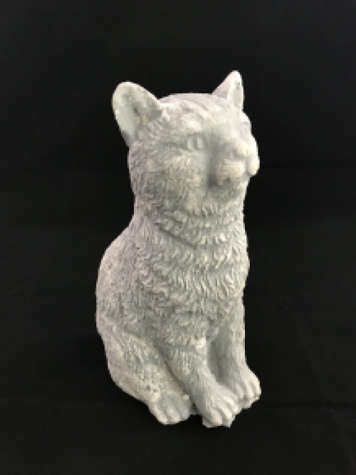 A beautiful sitting cat, made of stone, beautiful in detail