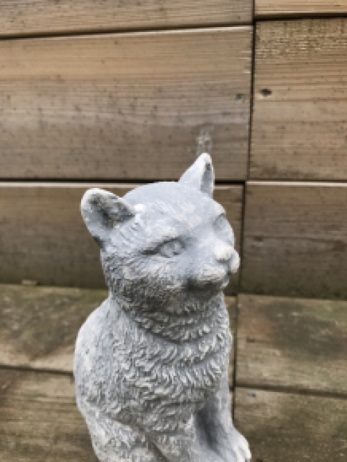 A beautiful sitting cat, made of stone, beautiful in detail